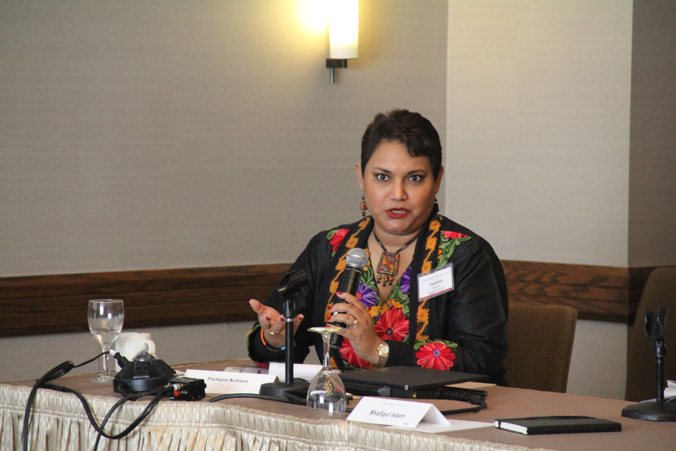 Dr. Farhana Sultana delivering a talk at Harvard University, 2014